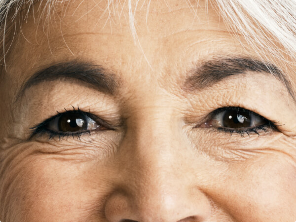 Close-up shot of a woman's face focused on her brown eyes. 
