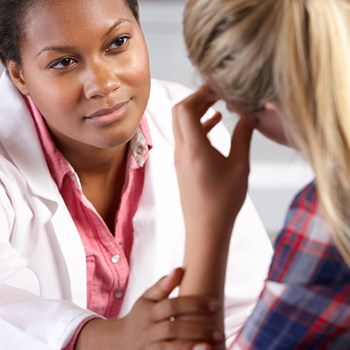 Female doctor listening attentively to a patient.