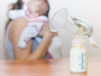 Breast pump and bottle on a table.