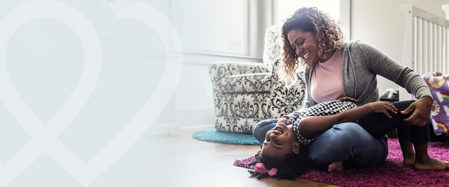 woman playing with her child with Women's Health Logo on the right side