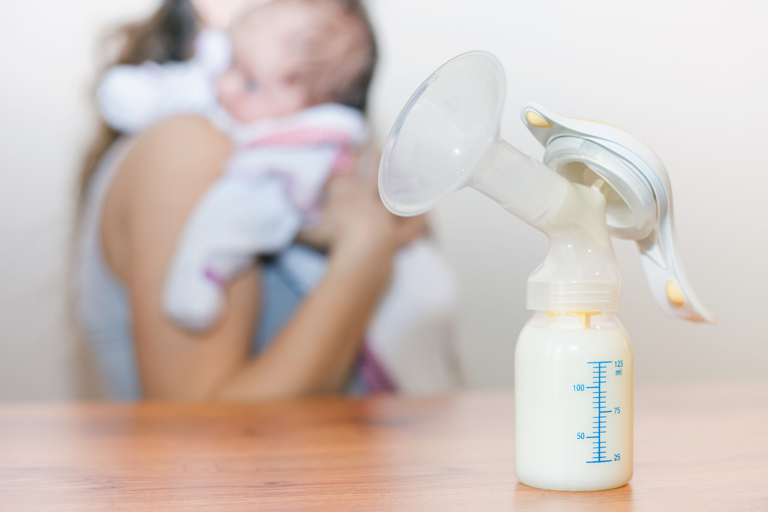 Breast pump and bottle on a table.