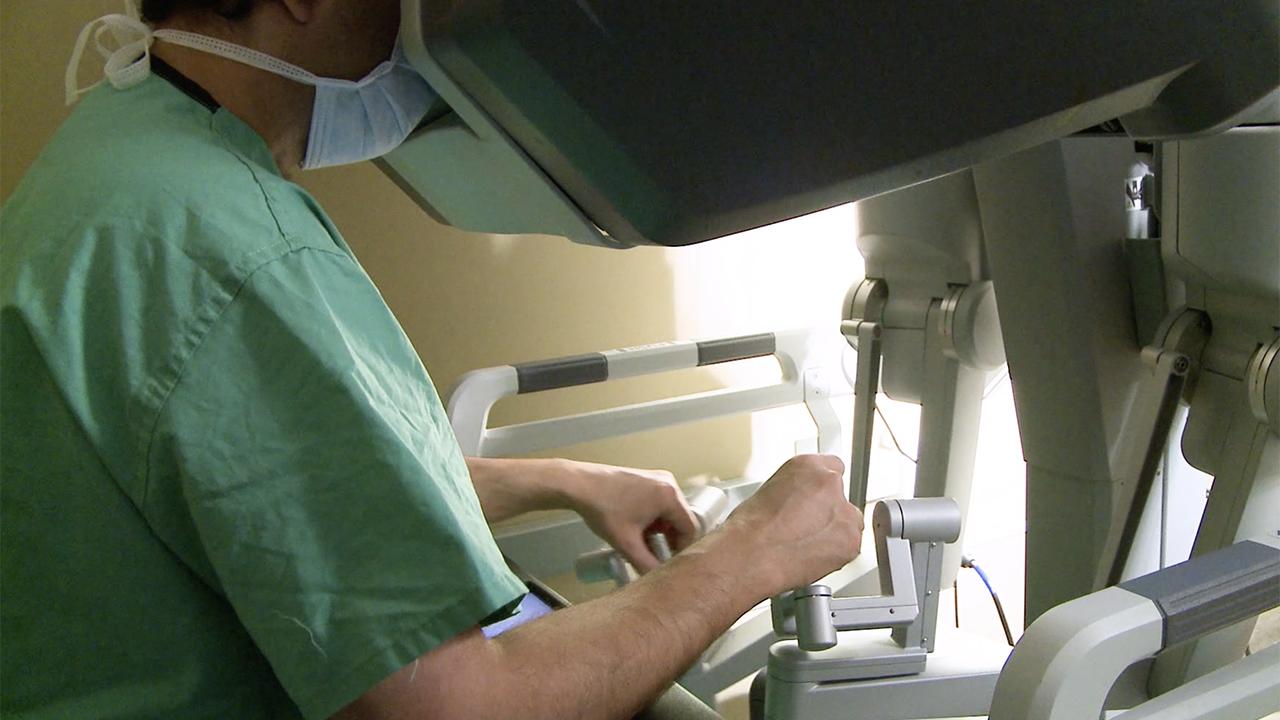 Doctor working a robotic device.