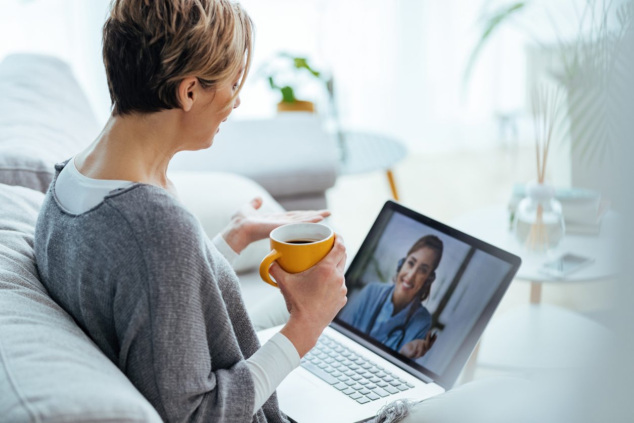 woman doing a virtual care visit on her laptop