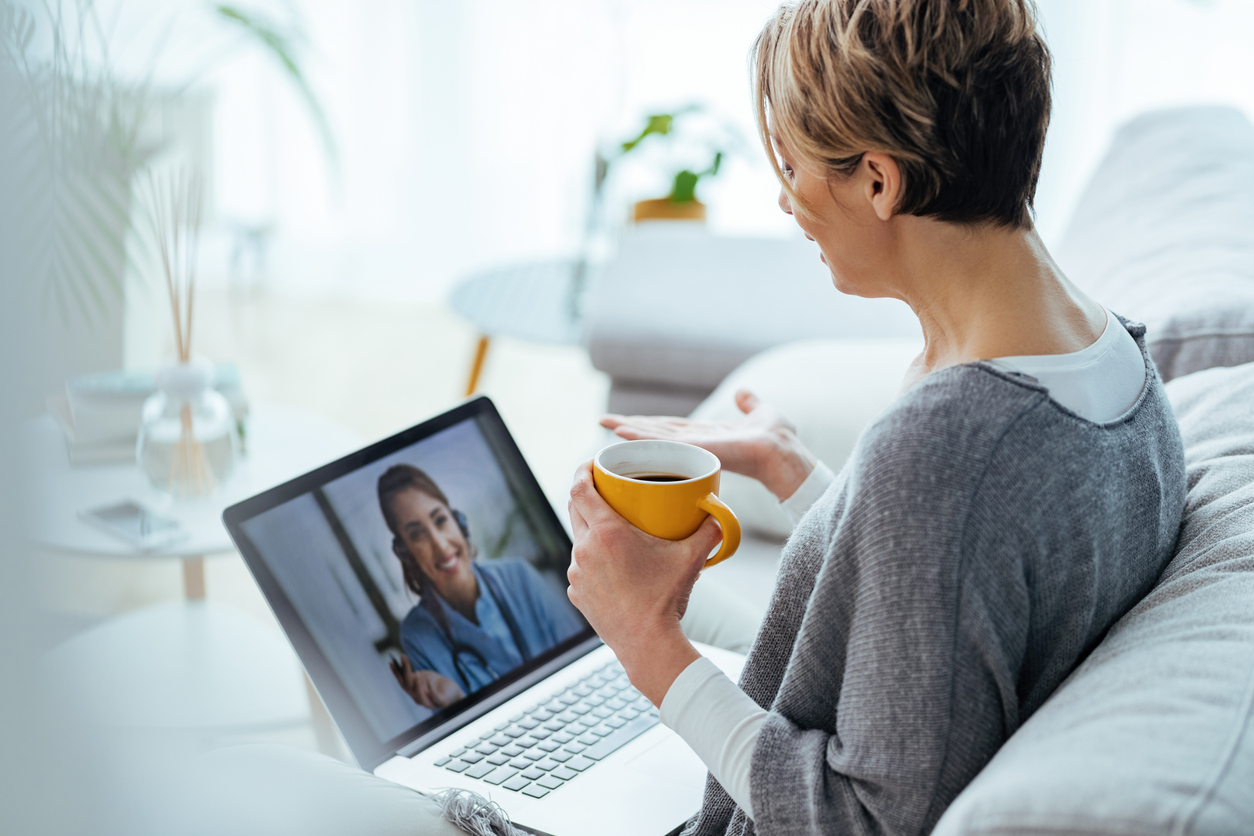 woman doing a virtual care visit on her laptop